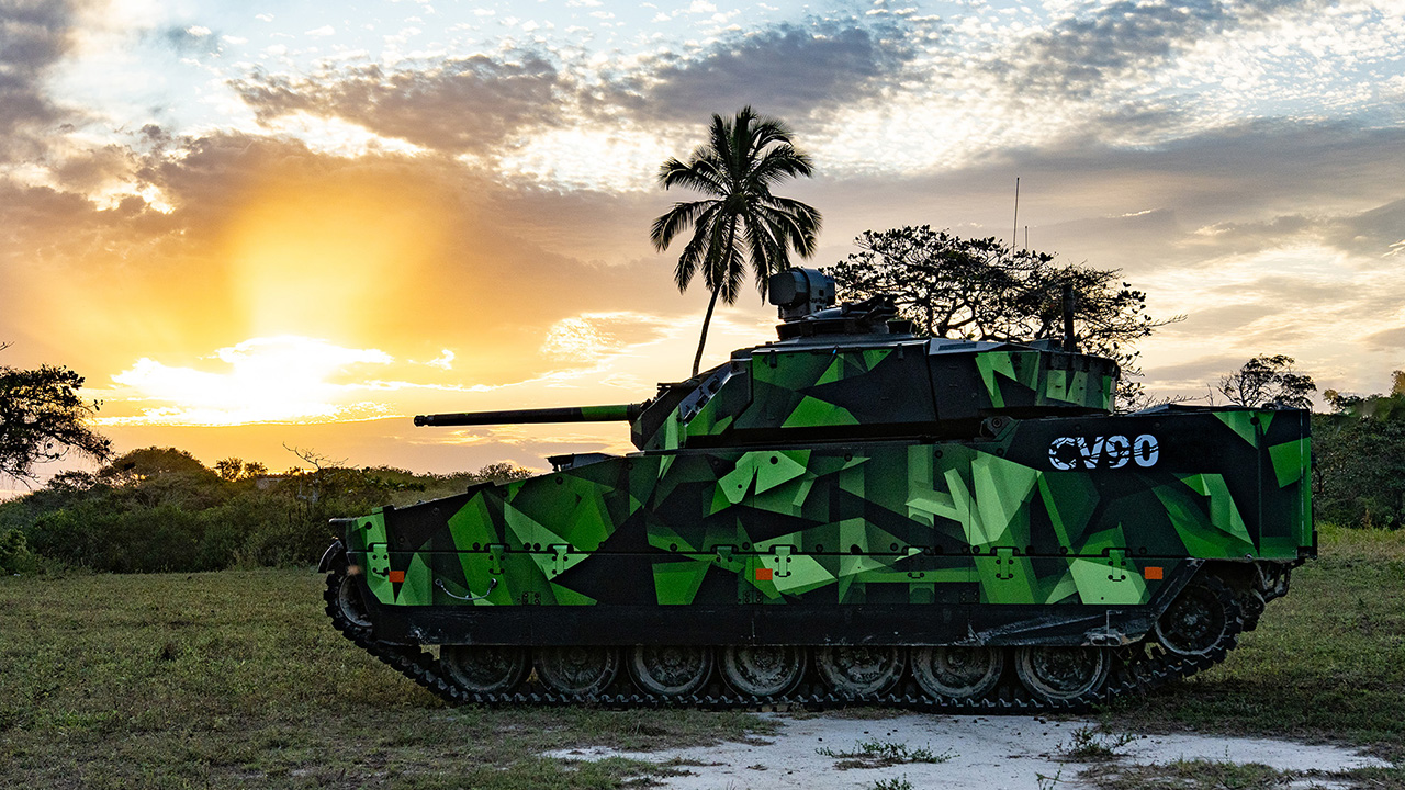 A green CV90 at sunset
