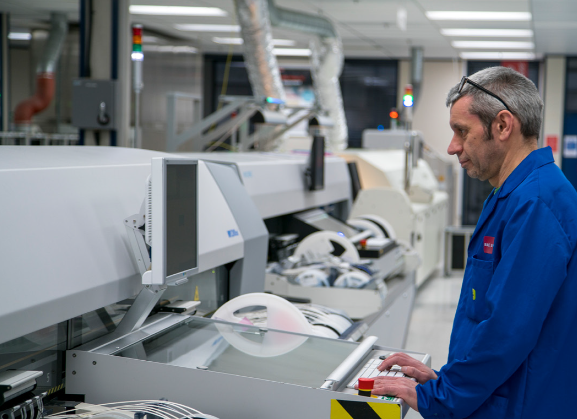 Image of man checking a circuit board