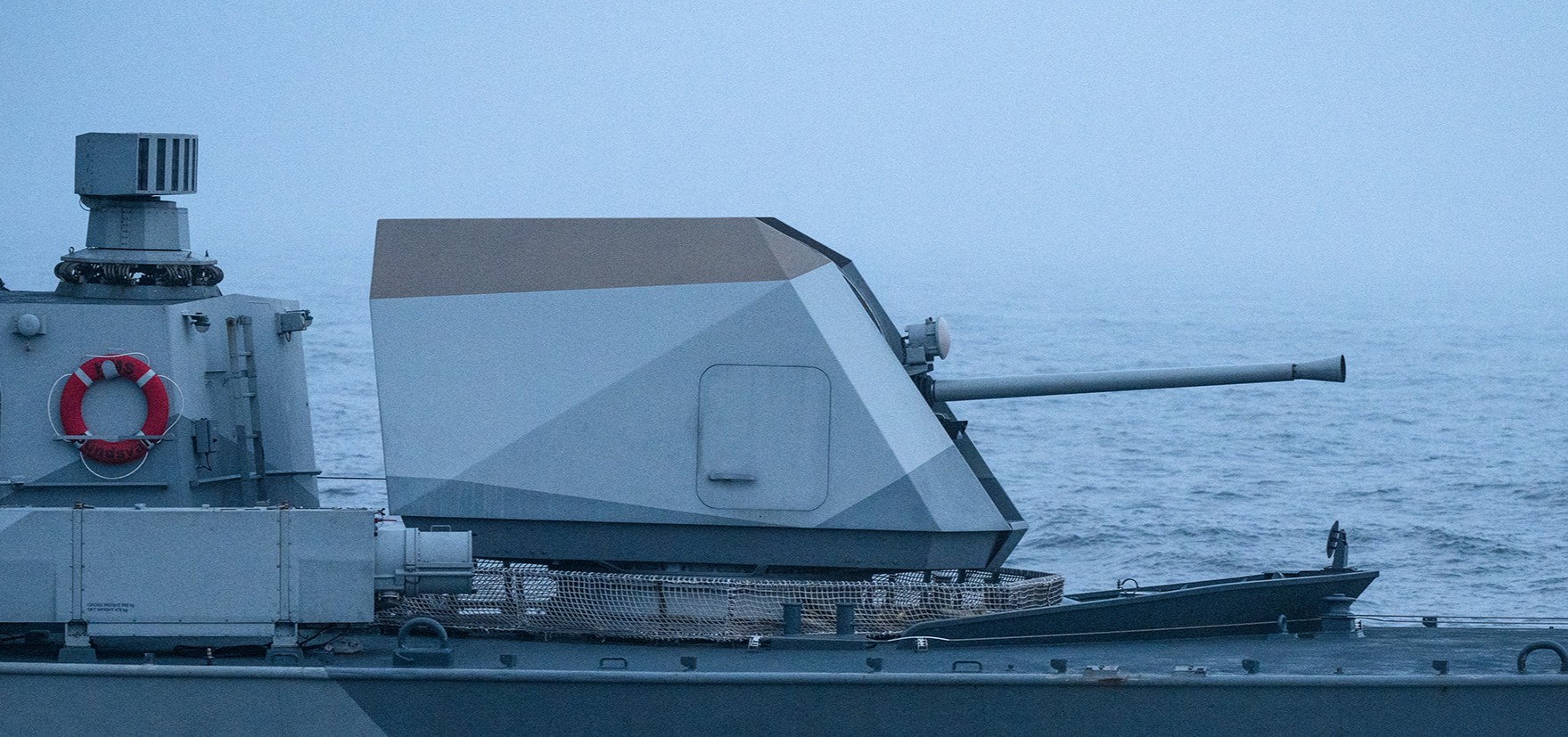 Bofors 57 Mk3 naval gun system mounted on the bow of a naval vessel underway at sea.