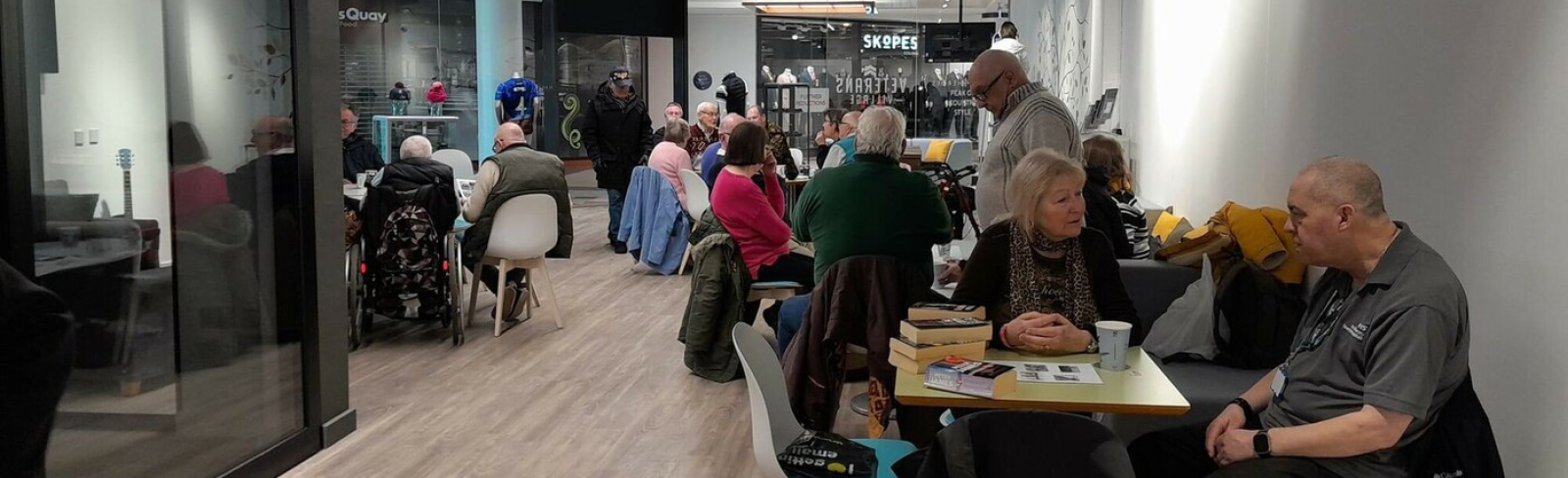 Veterans sitting at tables with books and coffee