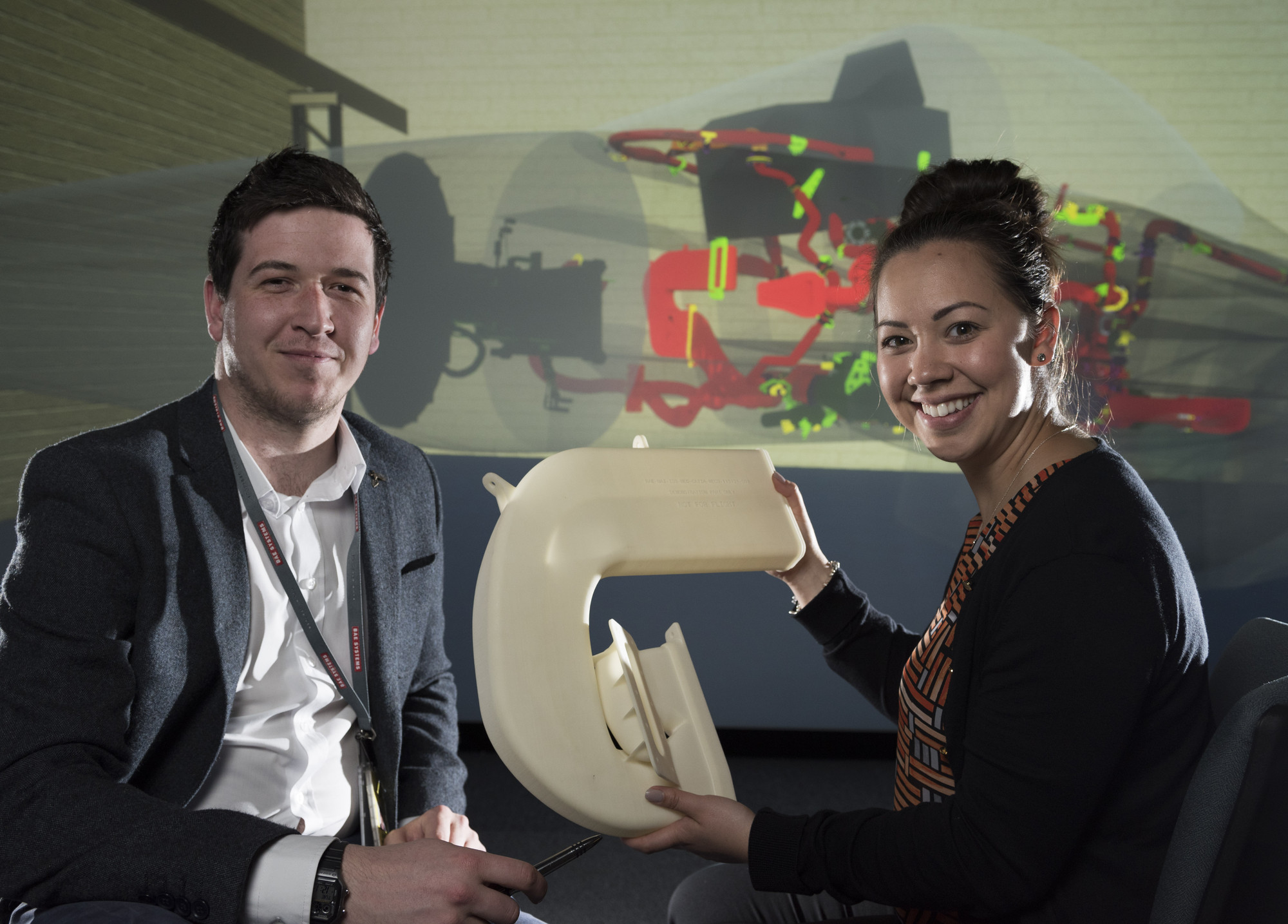 Engineers hold up a Typhoon cooling duct
