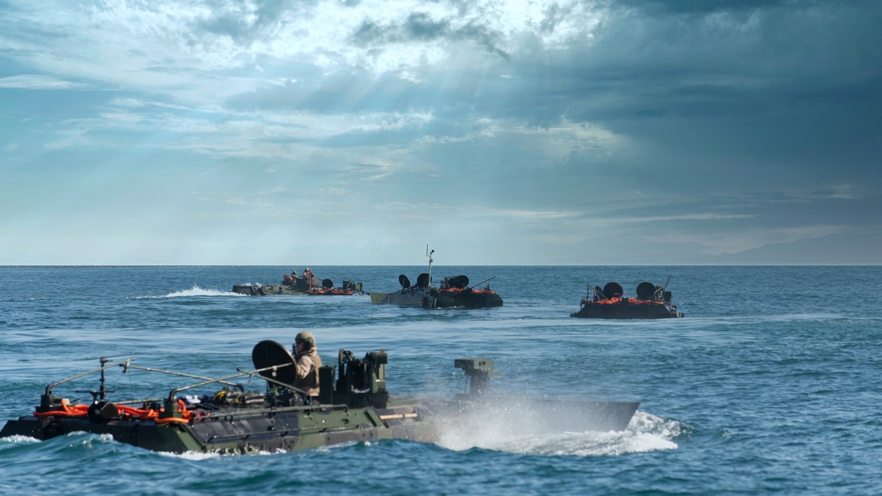 Four Amphibious Combat Vehicles conducting swim operations at United States Marine Corps base in California.