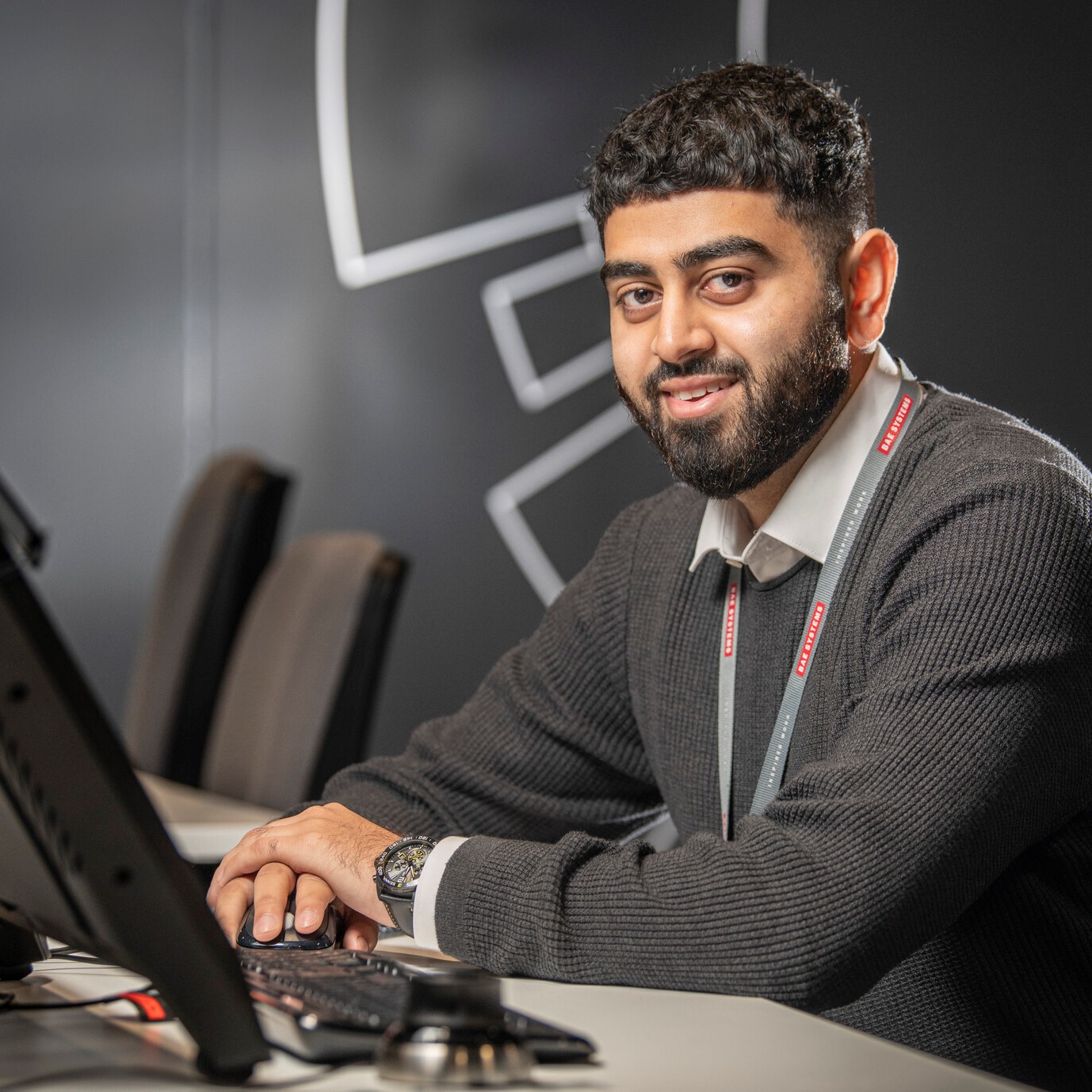 Umair sat at at computer