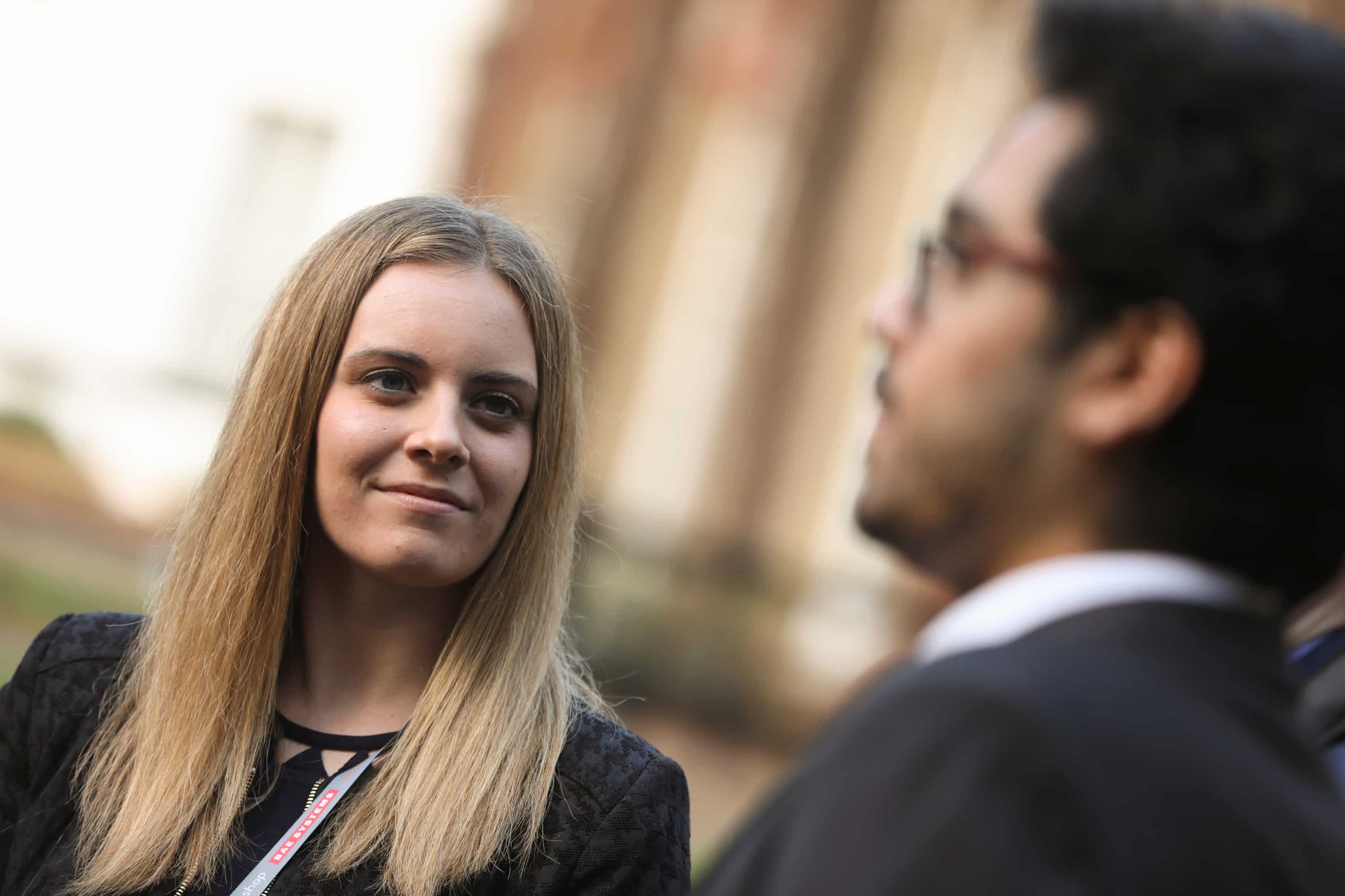 Young woman listening intently to a colleague