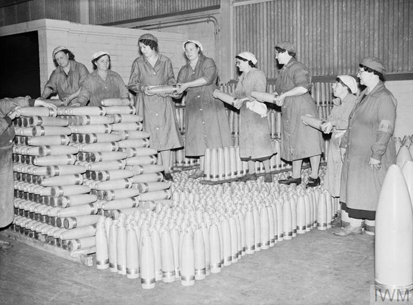 Munitions production in Britain - Women war workers form a chain as they stack piles of shells at a munitions factory during 1941 (credit: Imperial War Museum)