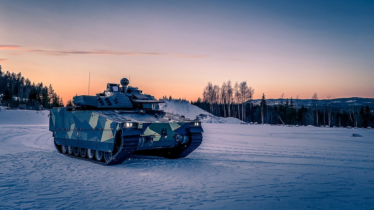 A CV90 MkIV parked in snow at sunset