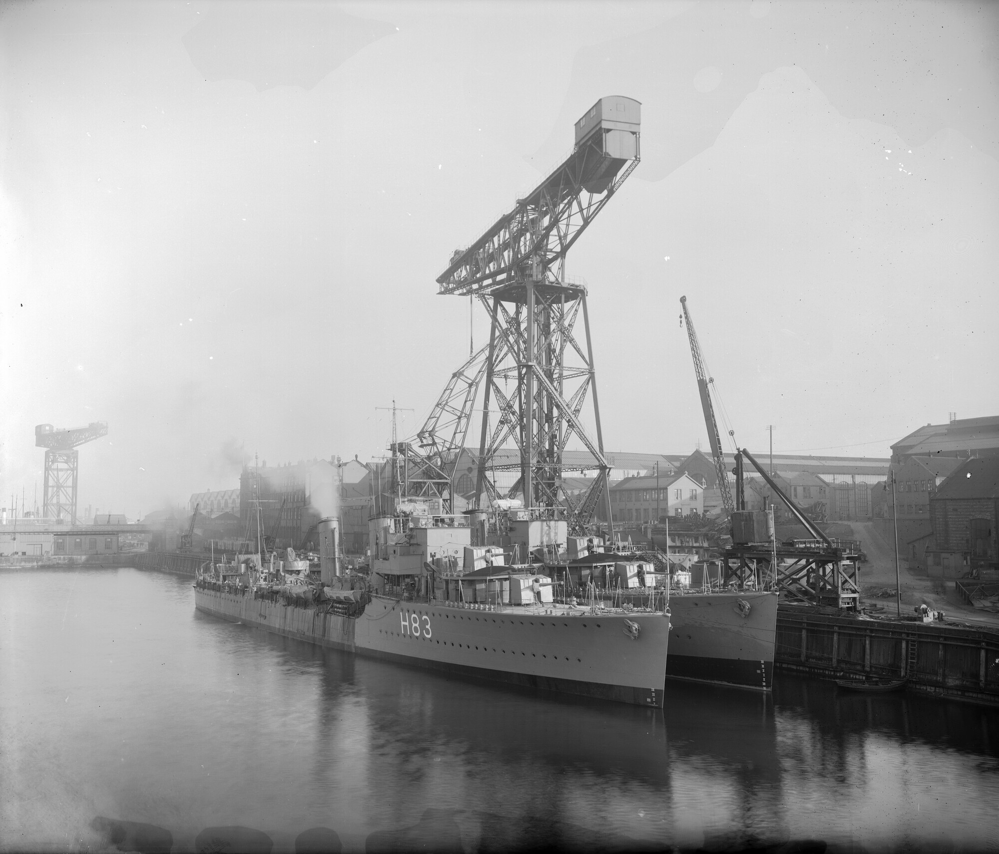 HMS Cygnet (pennant no H83) and HMS Crescent (C-class fleet destroyers) at the quayside, Devonshire Dock, Barrow, c.1932.