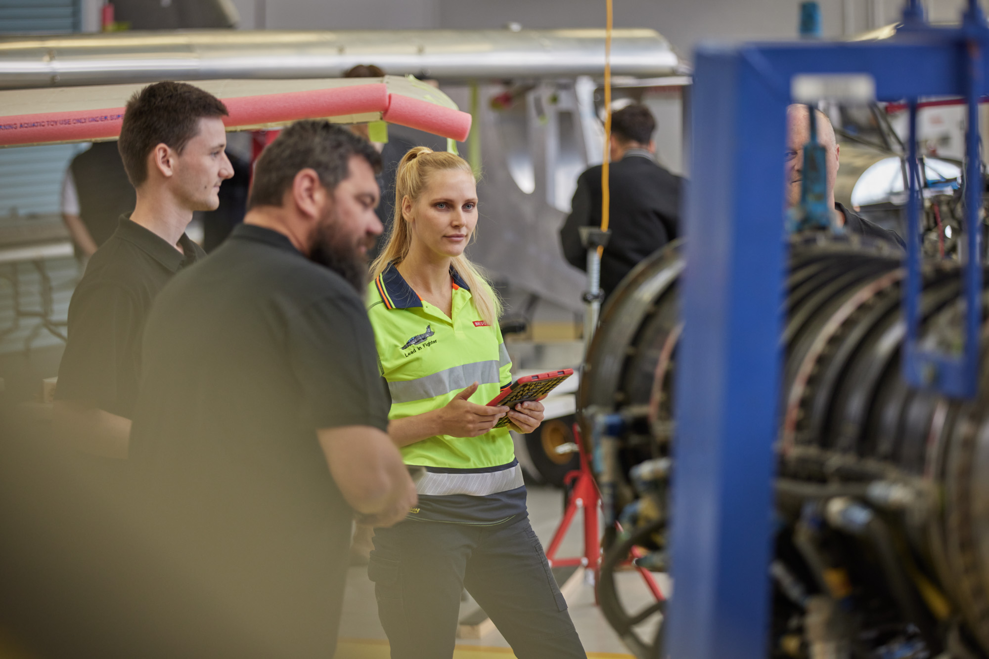 Aircraft technicians inspecting a Hawk Lead-in Fighter aircraft engine
