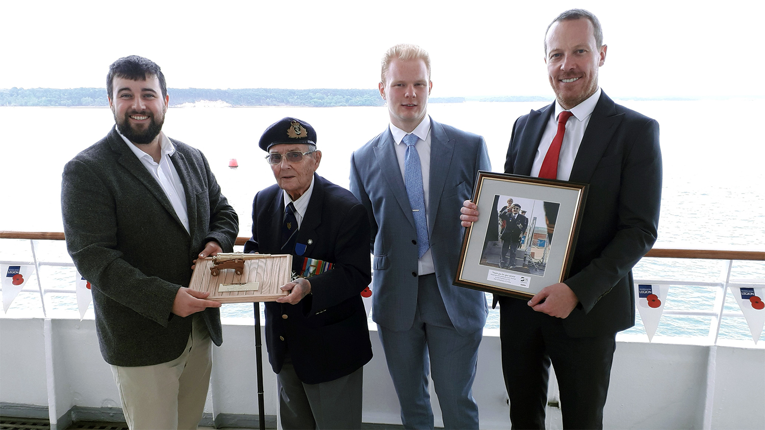 D-Day veteran Eric Strange being presented with his hand crafted cannon and framed photo from BAE Systems
