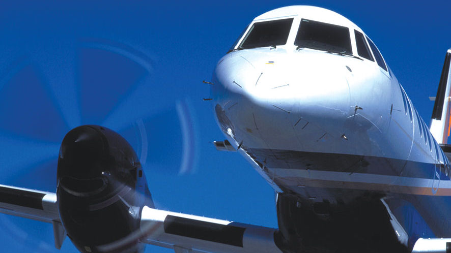 J14 with spinning propeller close up against a blue sky background