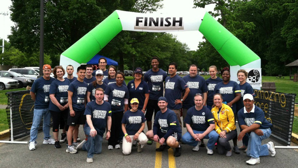 BAE Systems’ employees gather at the finish line.