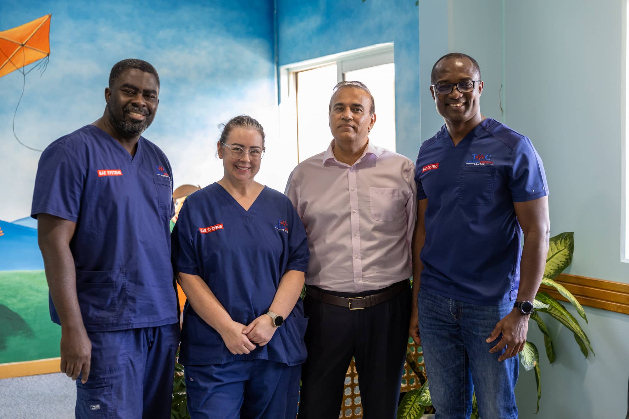 Four employees posing for a photo