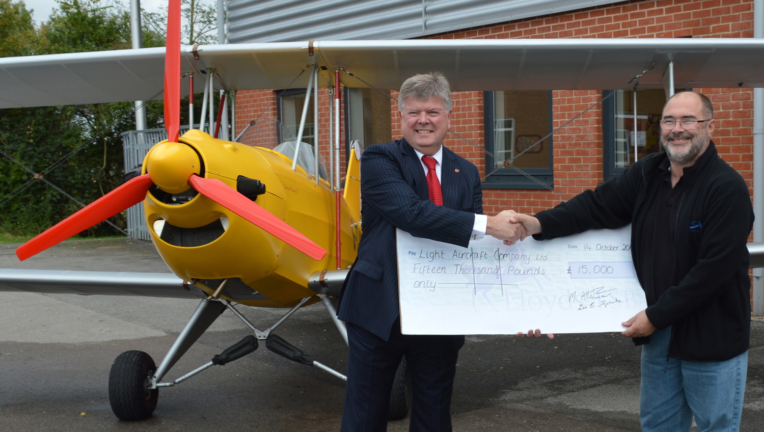 Martin Blaze presenting Paul Hendry-Smith (MD of The Light Aircraft Company) with a cheque to purchase the fuselage of the Sherwood Ranger.