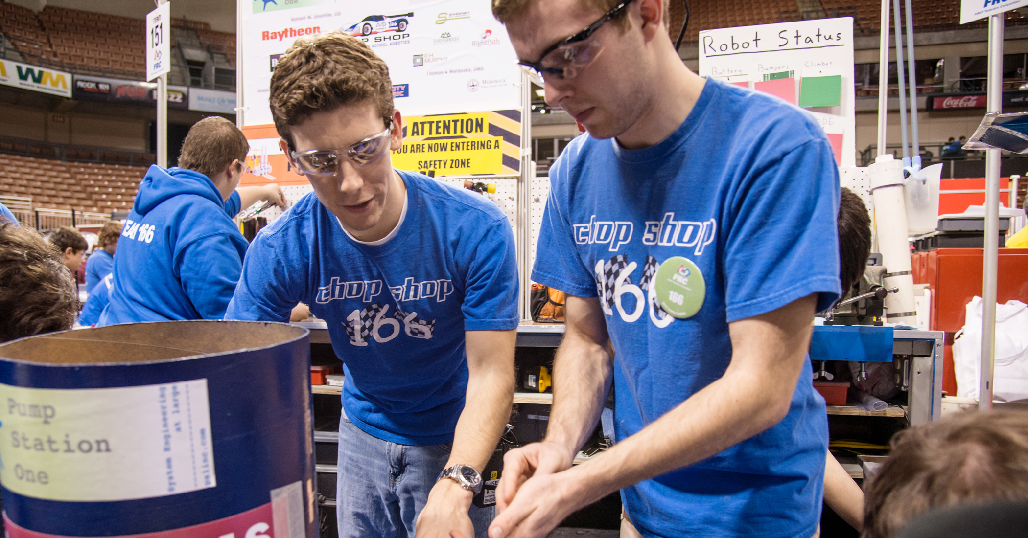 Brian Belley of BAE Systems mentors Alex Elmer of Merrimack High School during a practice session at the FIRST Granite State Regional Competition in Manchester, NH