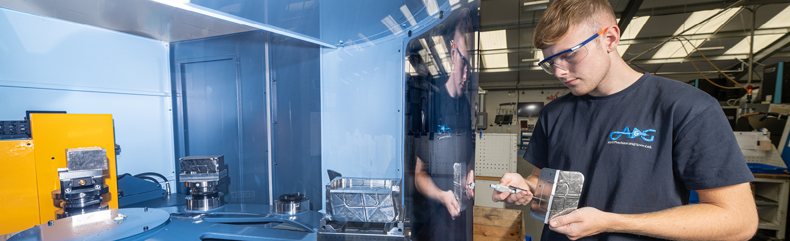 An employee at A&G Precision works on a piece of machinery.