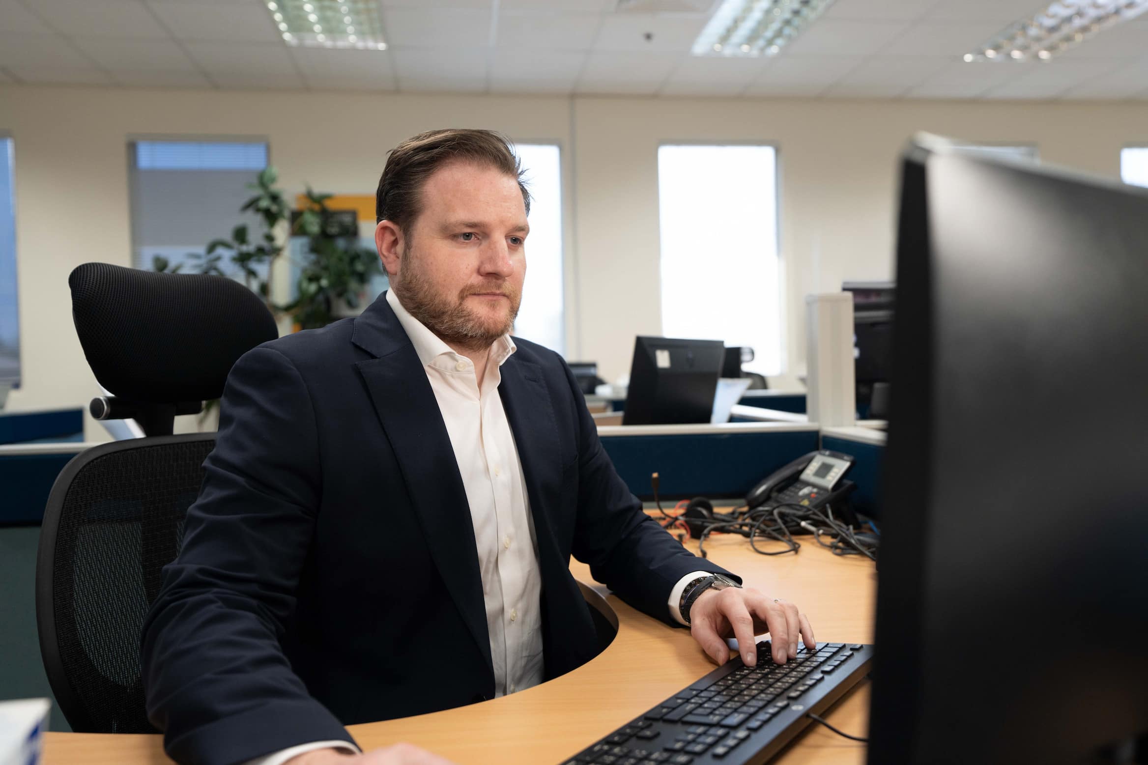 Expat employee at computer in office