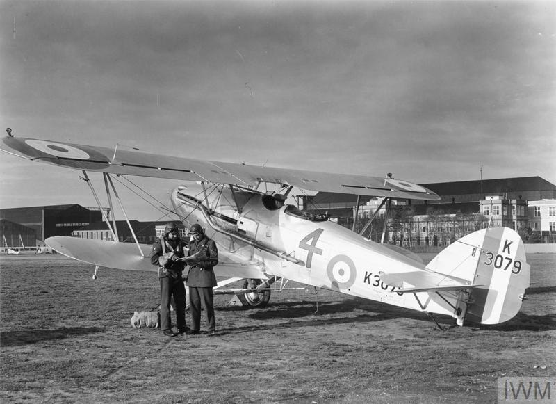 IWM (H(AM) 229) - Crew of a Hawker Audax of 4 Squadron, Royal Air Force, check their map before undertaking a flight from Farnborough, c. 1935.