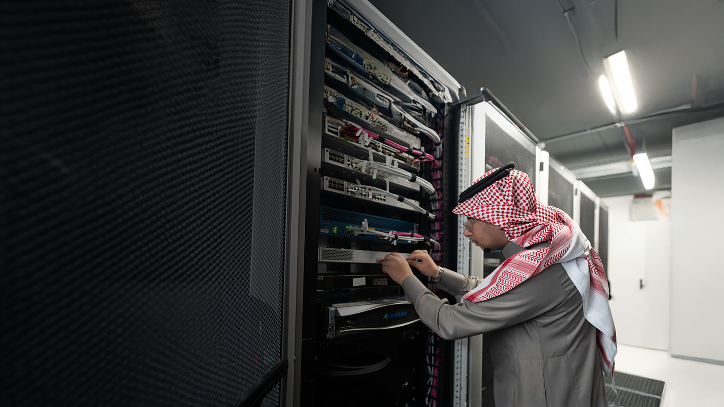 BAE Systems employee in Saudi Arabia accessing a server cupboard