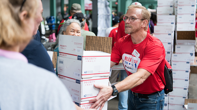 Employees help with packages to be sent to deployed soldiers