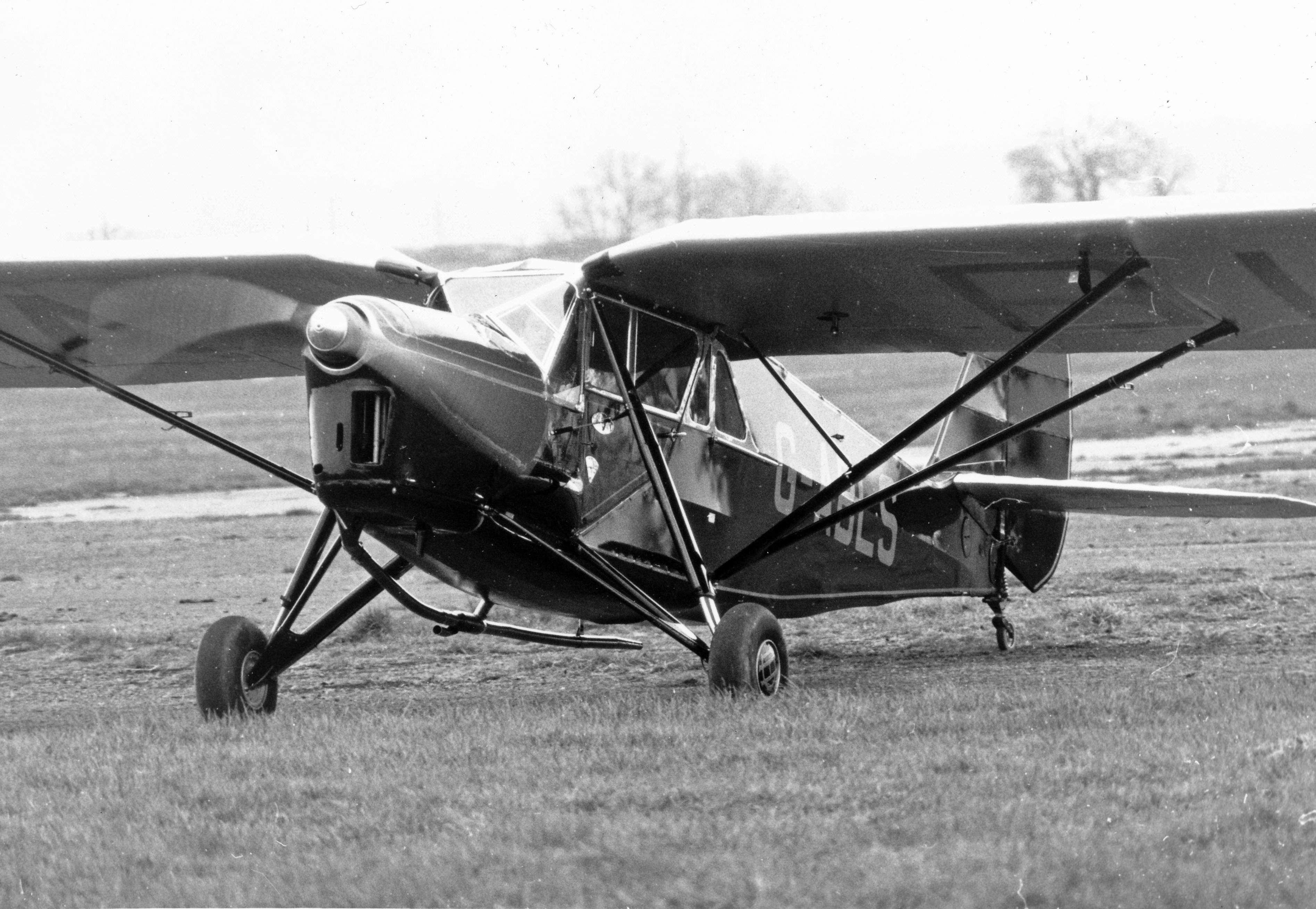 DH 80 Puss Moth parked on airfield