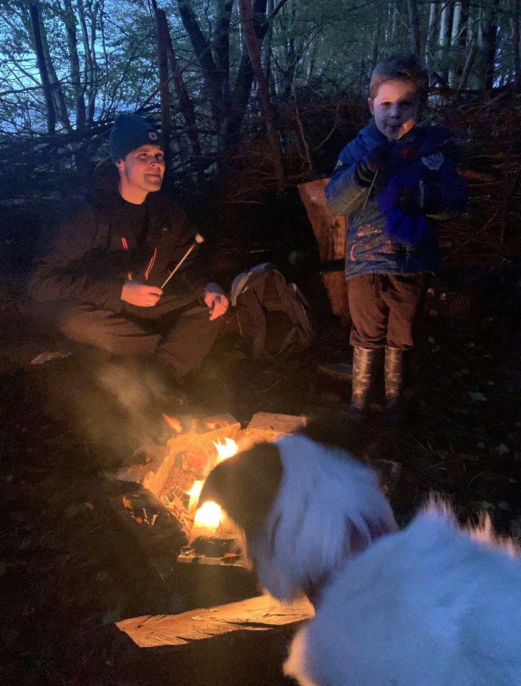 James, son and dog toast marshmallows on open fire