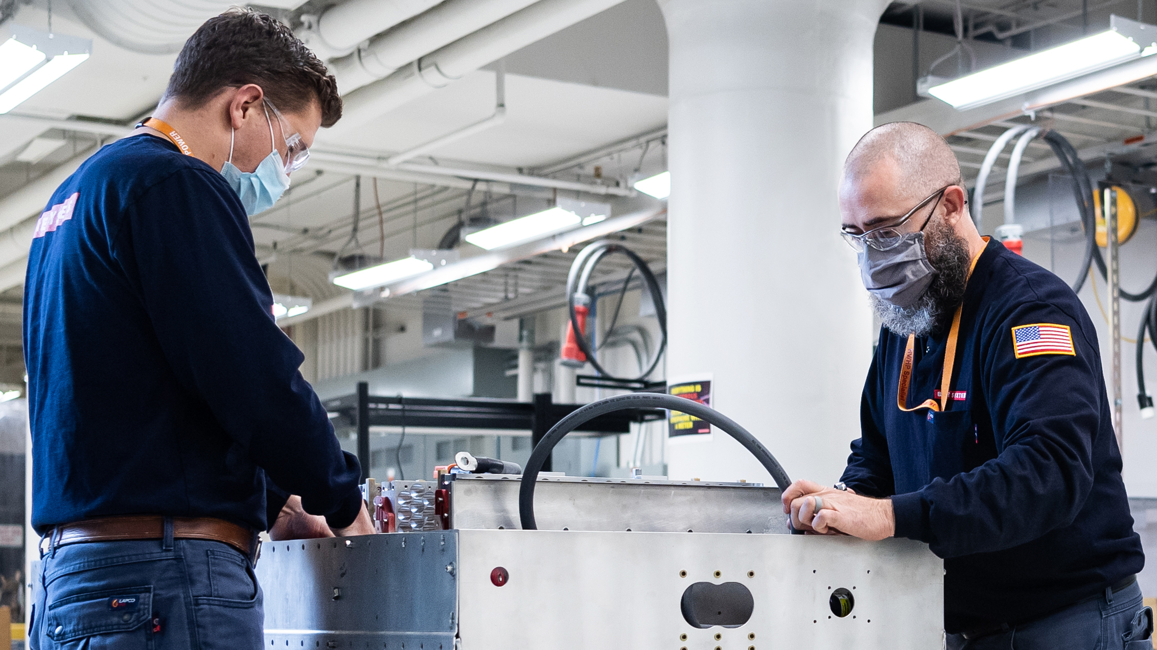 BAE Systems employees working on product in the electrification lab.