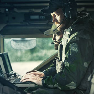 Two soldiers at a computer