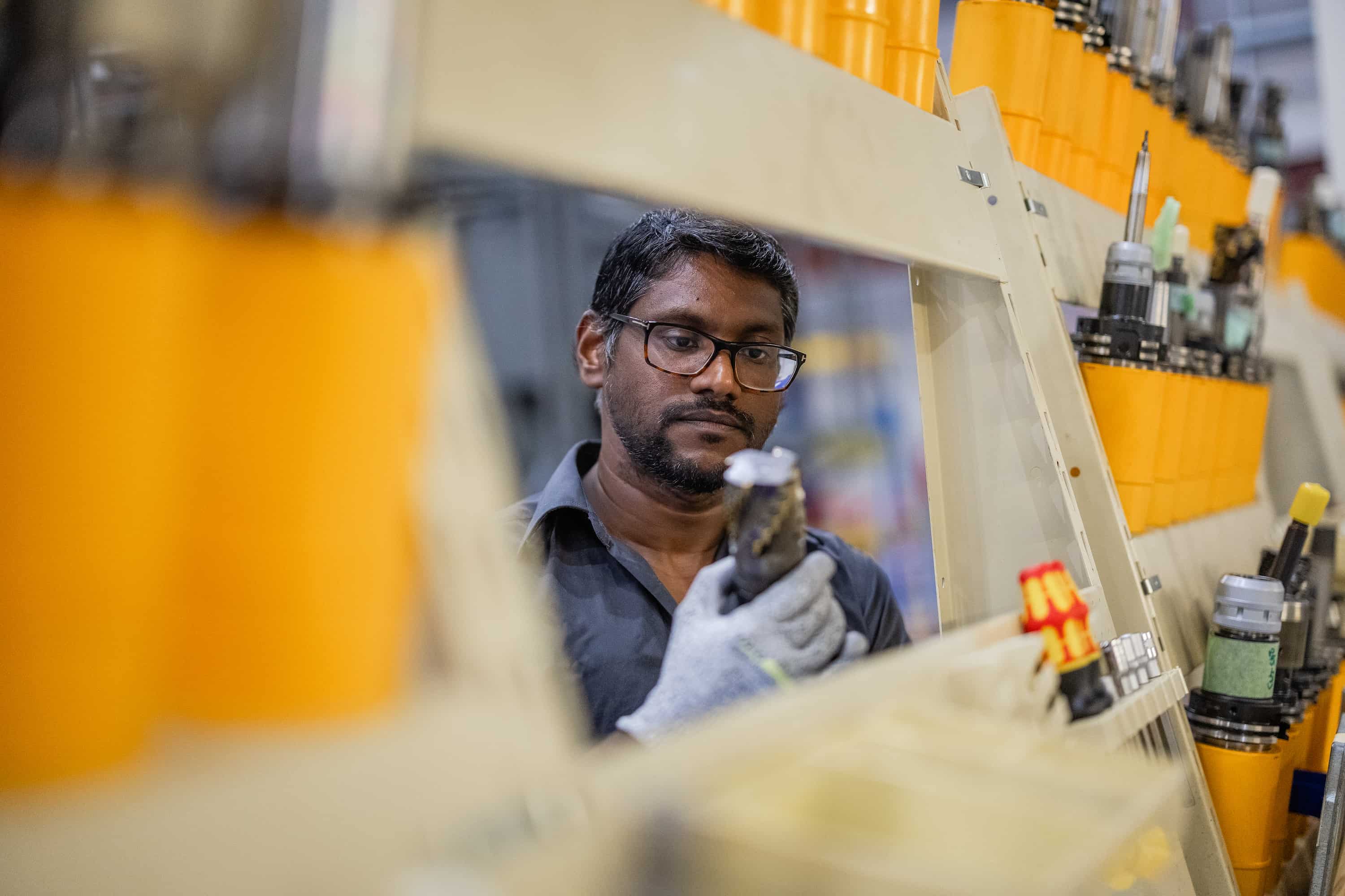Employee behind a well-stocked tool rack
