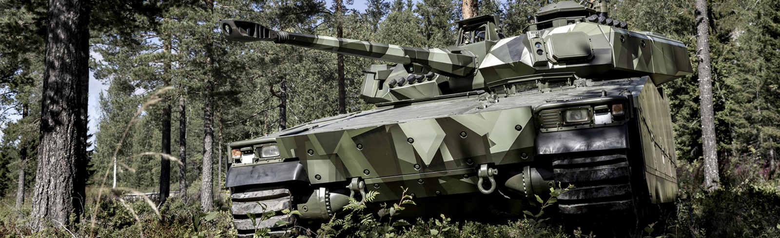 CV90 MkIV blending into a dense forest background