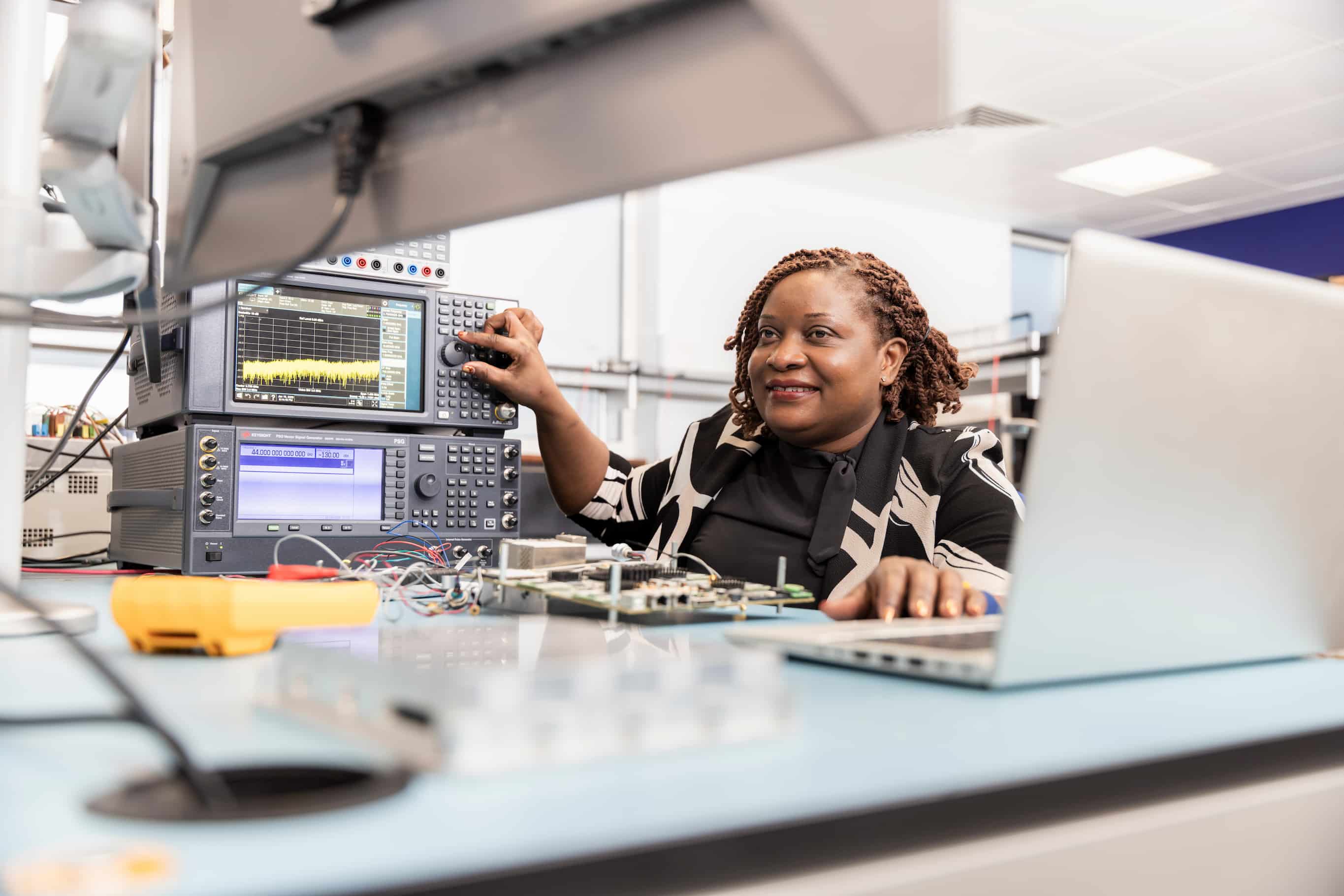 Women adjusting complex technology setup