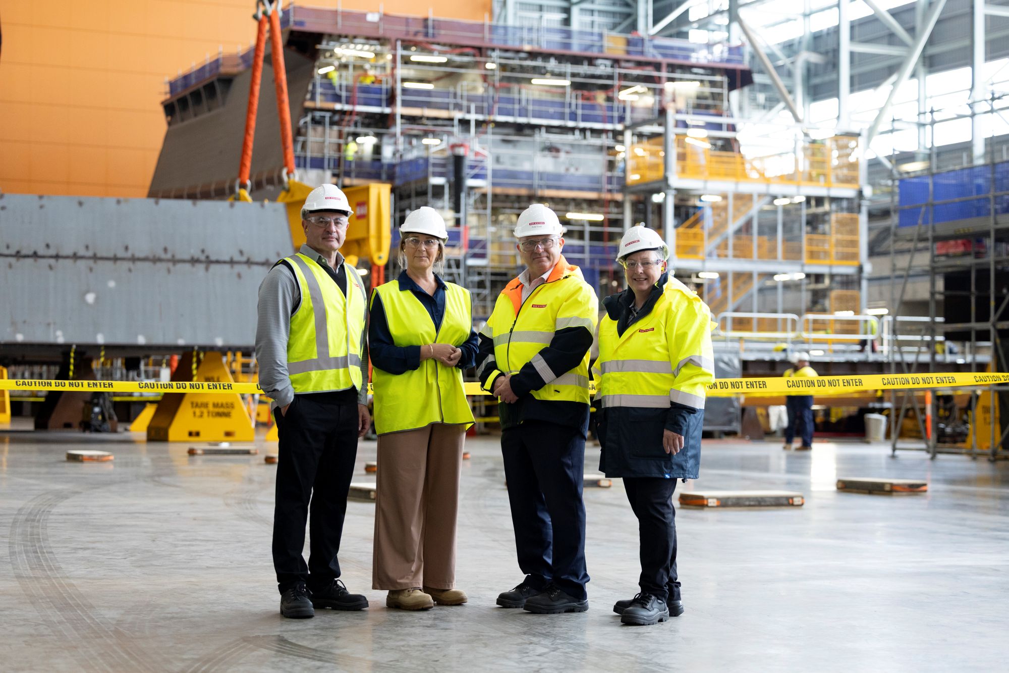 Defence Seals & Spares and BAE Systems employees posing for a photo inside the Osborne Naval Shipyard