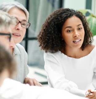 Photograph of a diverse group of people in a meeting