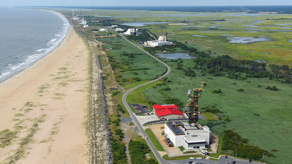 A BAE facility and parking lot opposite a beach and the ocean