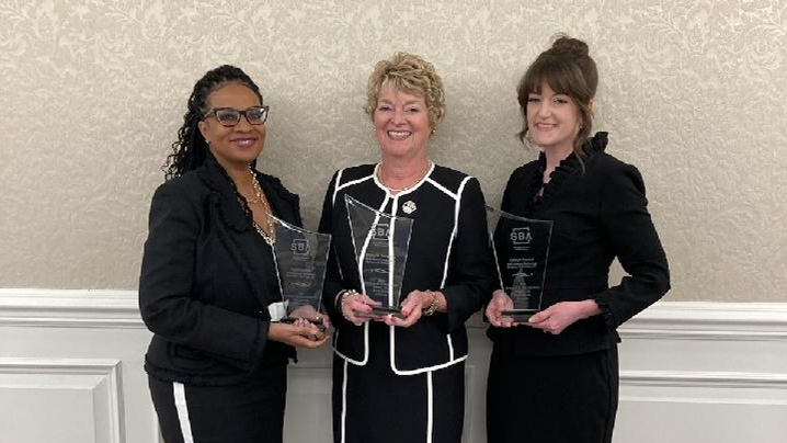 (From left to right) Dawn Dunlop, Diane Dempsey, and Katelyn Russell from BAE Systems Intelligence & Security small business office with the Dwight D. Eisenhower Award for Excellence.
