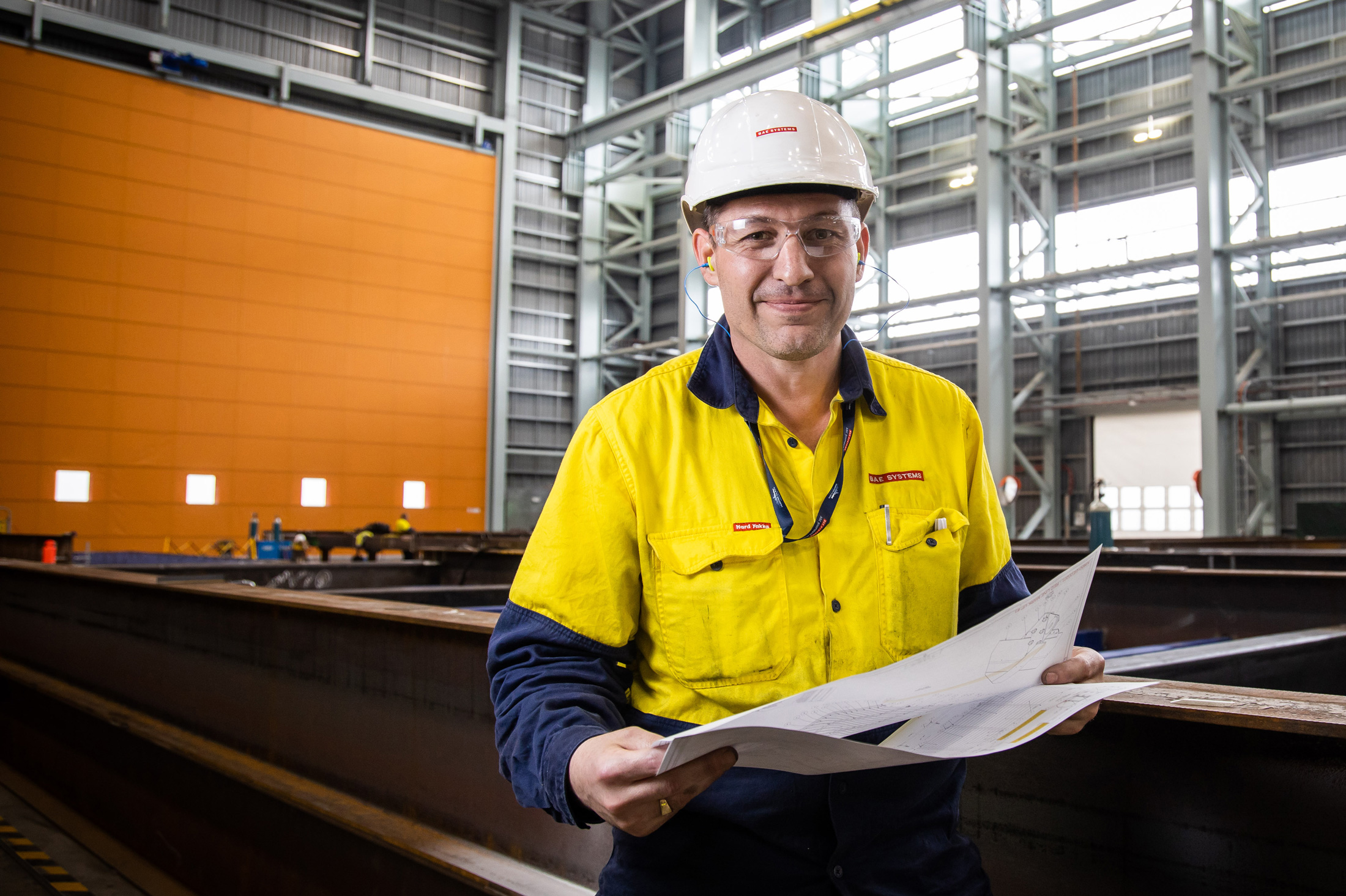 Neil in the shipyard reading over documents prior to starting work