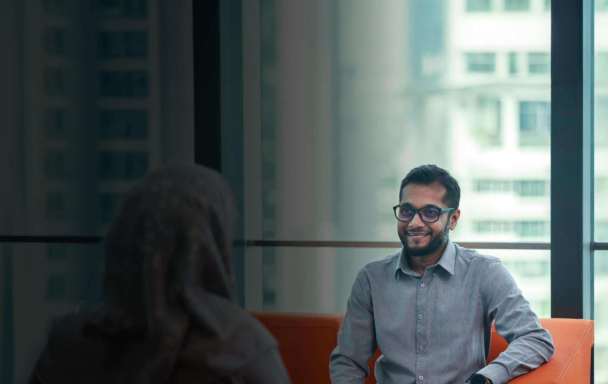 Man smiling at colleague