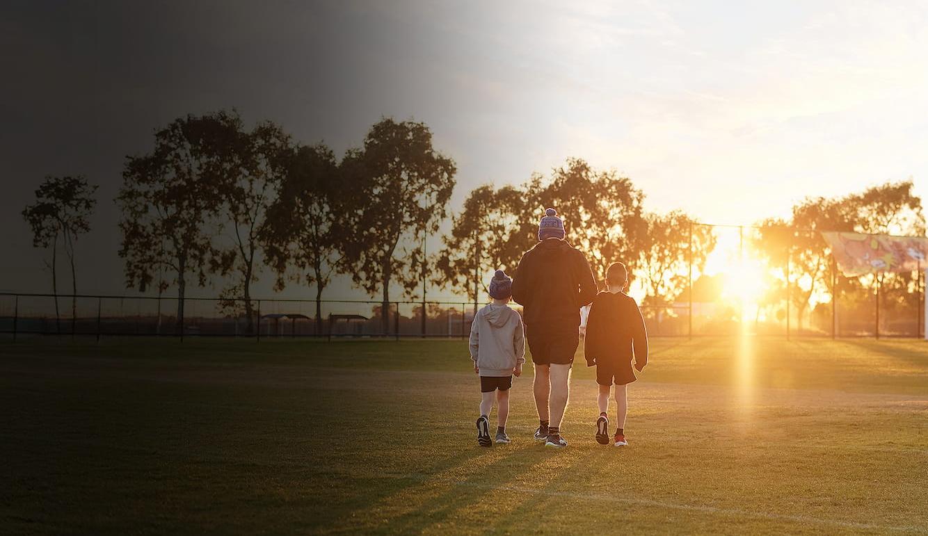 Happy family next to football field