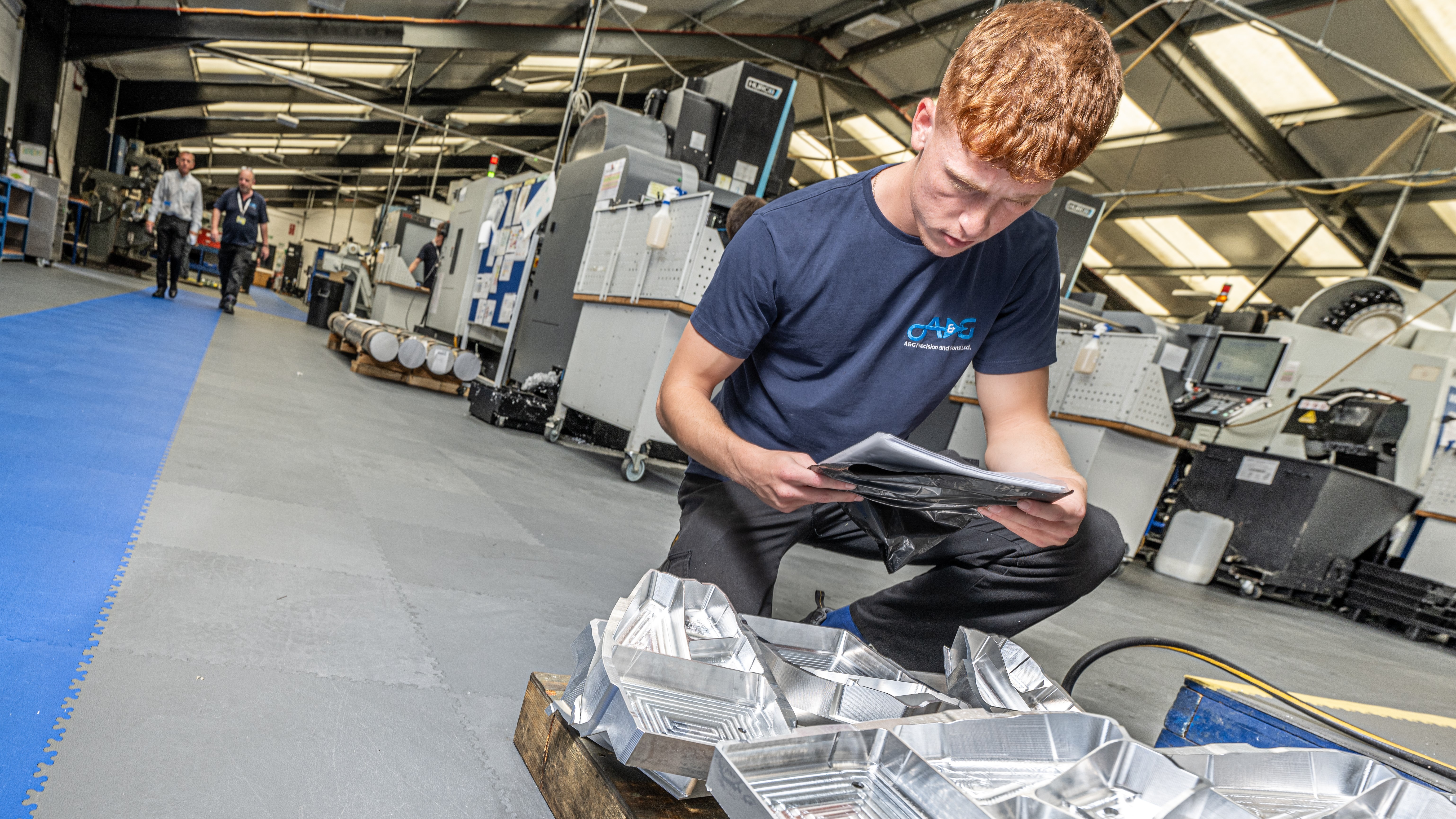 An employee inspects components at A&G Precision's facility in Lancashire.