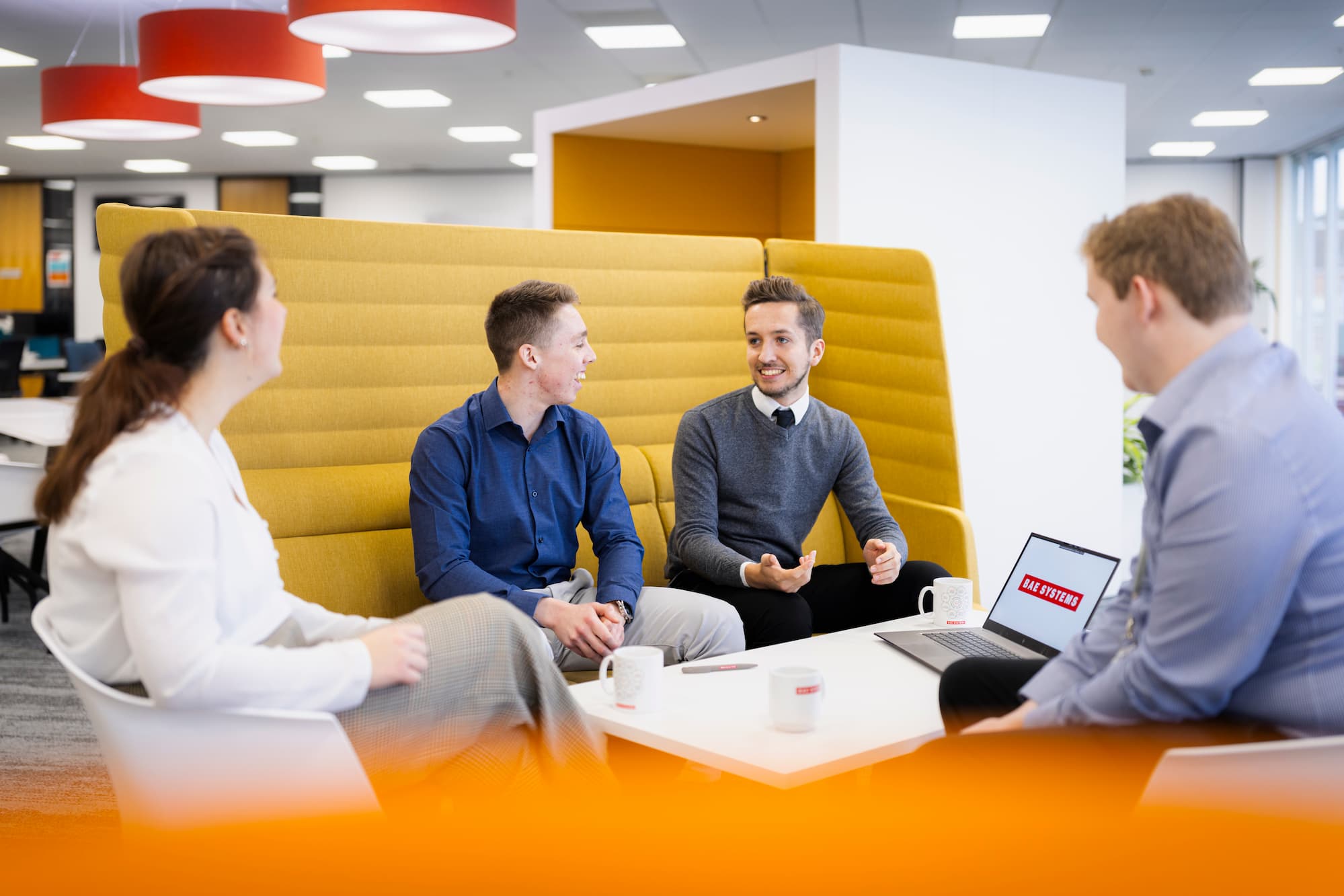 Employees in well-lit modern office having a meeting