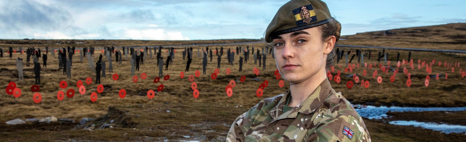 Rhian posing in front of war memorial silhouette soldier sculptures