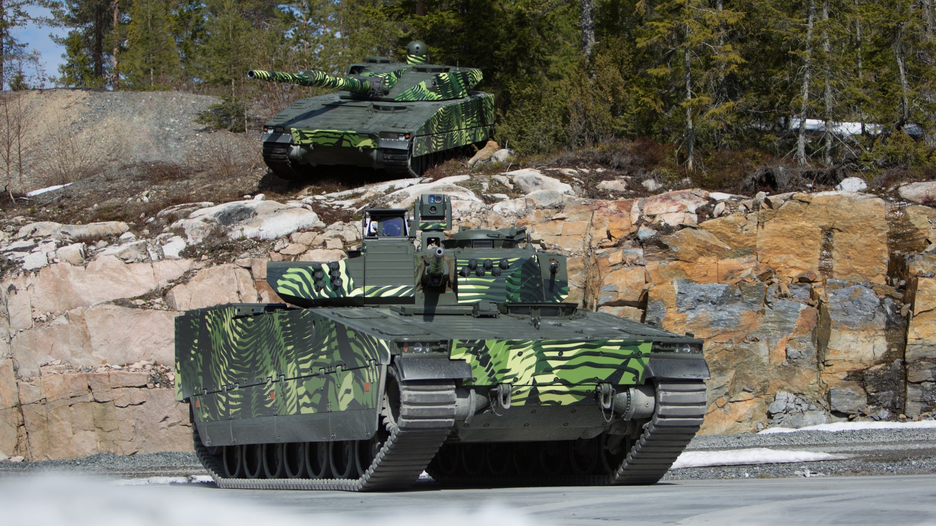The combat-proven CV90 and CV90120 positioned on rocky terrain at the edge of a forest. Multiple variants of the CV90 are offered to Slovakia in a joint bid with the Swedish FMV.