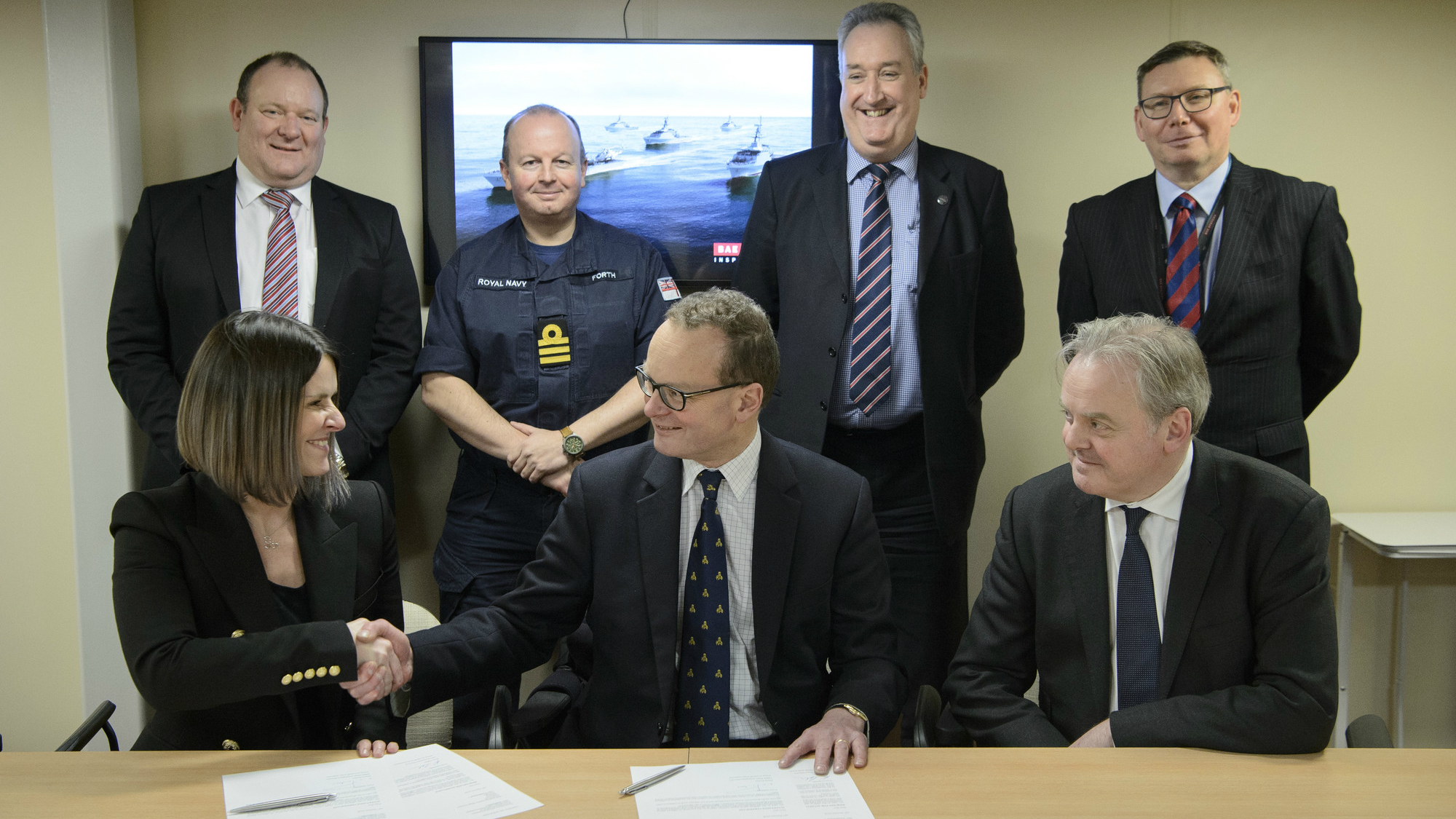 Image of Katie Callan, OPV Programme Director, shaking hands with Henry Parker, Director Ship Acquisition for Defence, Equipment & Support 