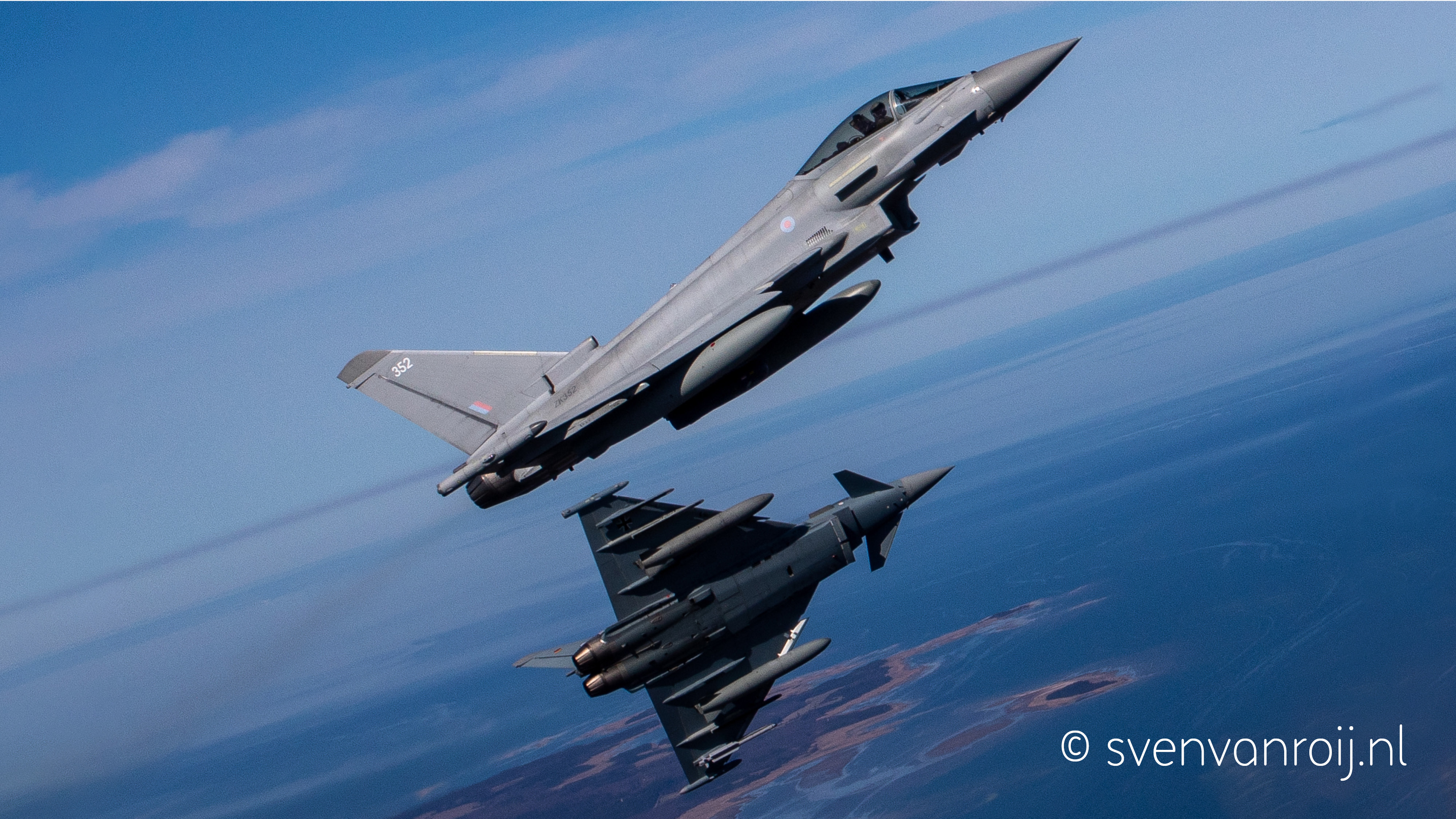 Royal Air Force and German Air Force Typhoons fly together during NATO Air Policing