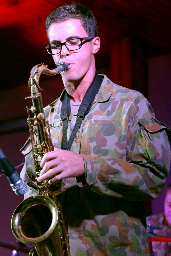 Legacy Centenary Torch Relay torch bearer Jason playing the saxophone