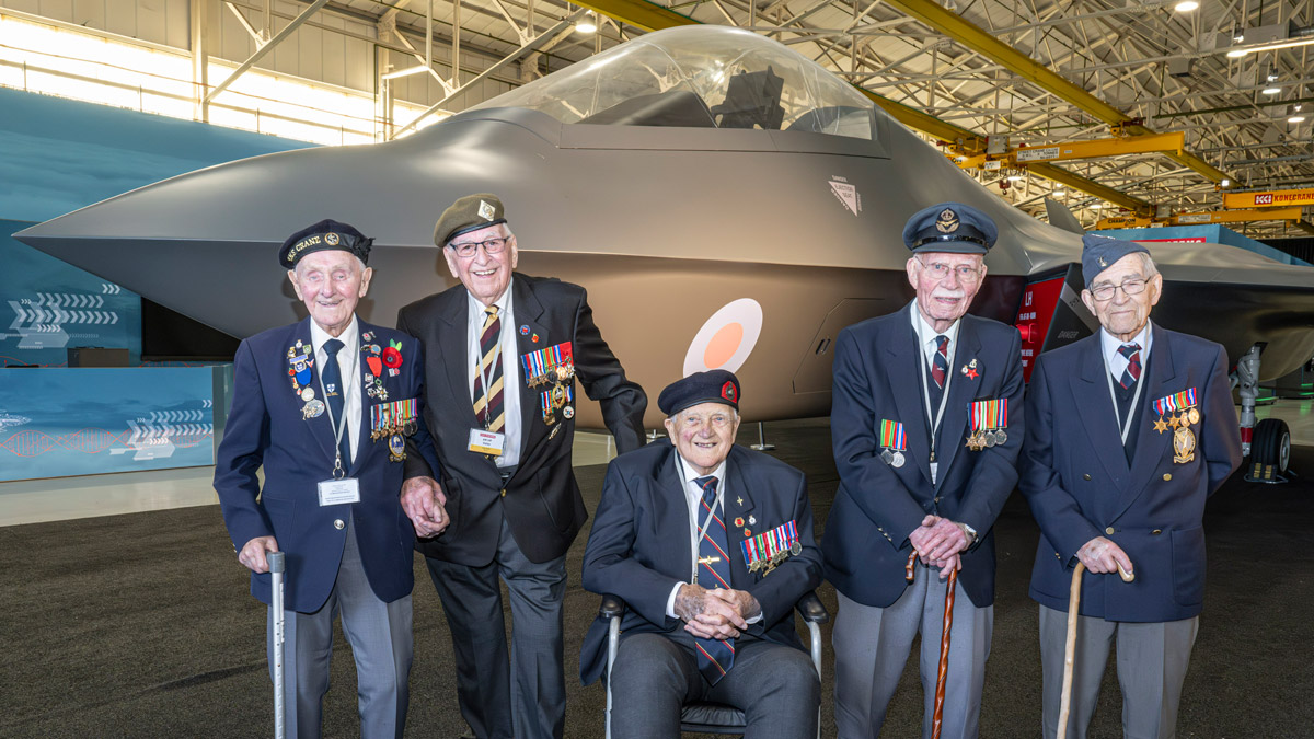 Two volunteers pose for a photo at the Standing with Giants installation between Gold Beach and the British Normandy Memorial in Ver-sur-Mer, France.