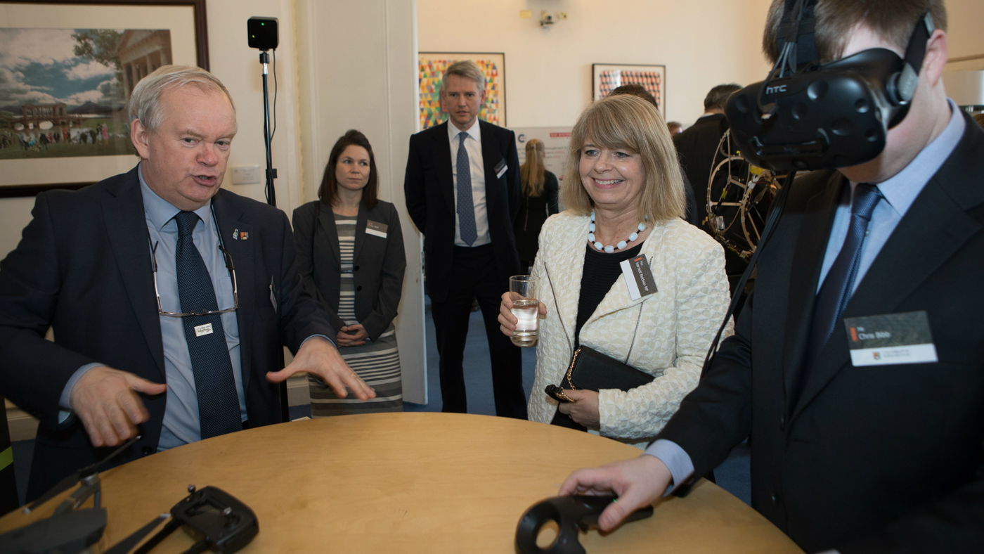 Image of attendees using VR Headset, including UK Minister for Defence Procurement Harriett Baldwin MP