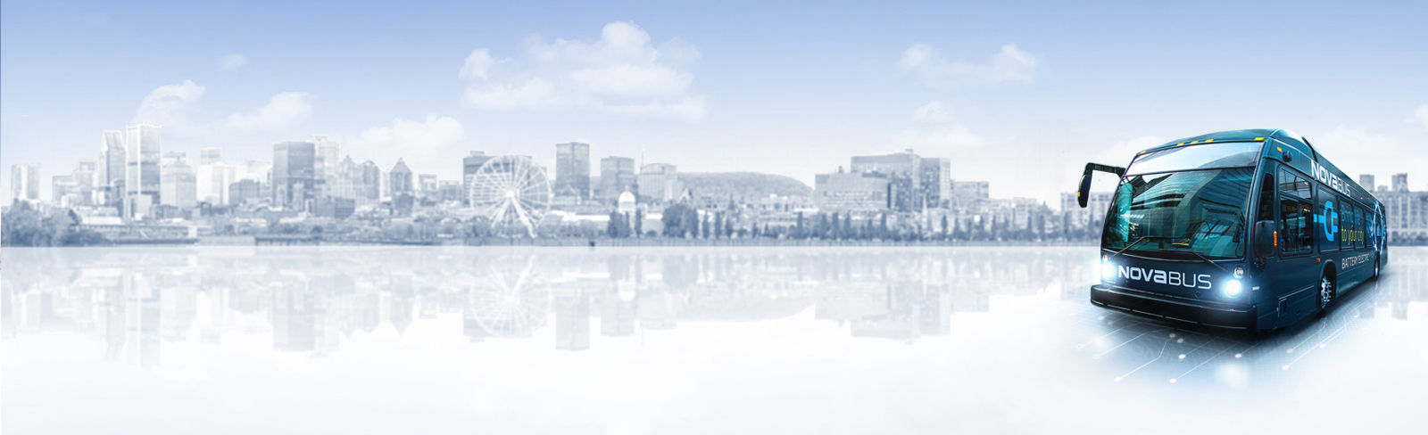 Transit bus with electric elements underneath in front of a city skyline