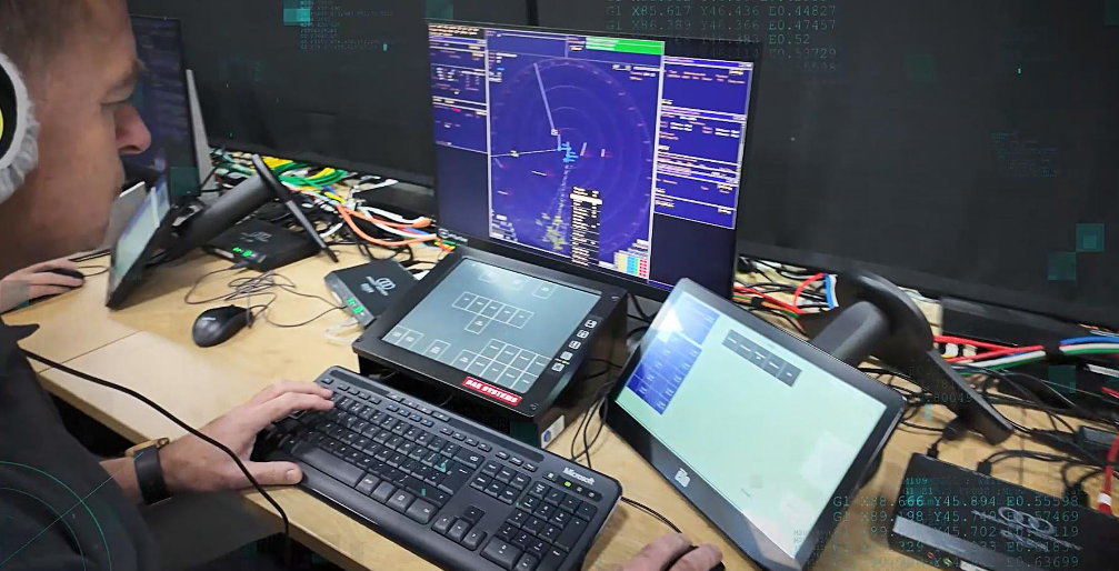 Image of operator at the helm of screens simulating battlespace