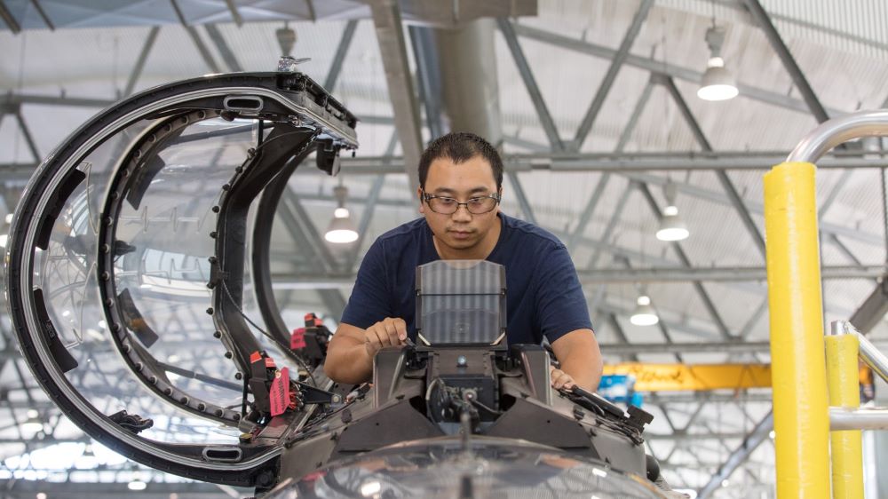 A BAE Systems aircrew technician working on a Hawk aircraft.