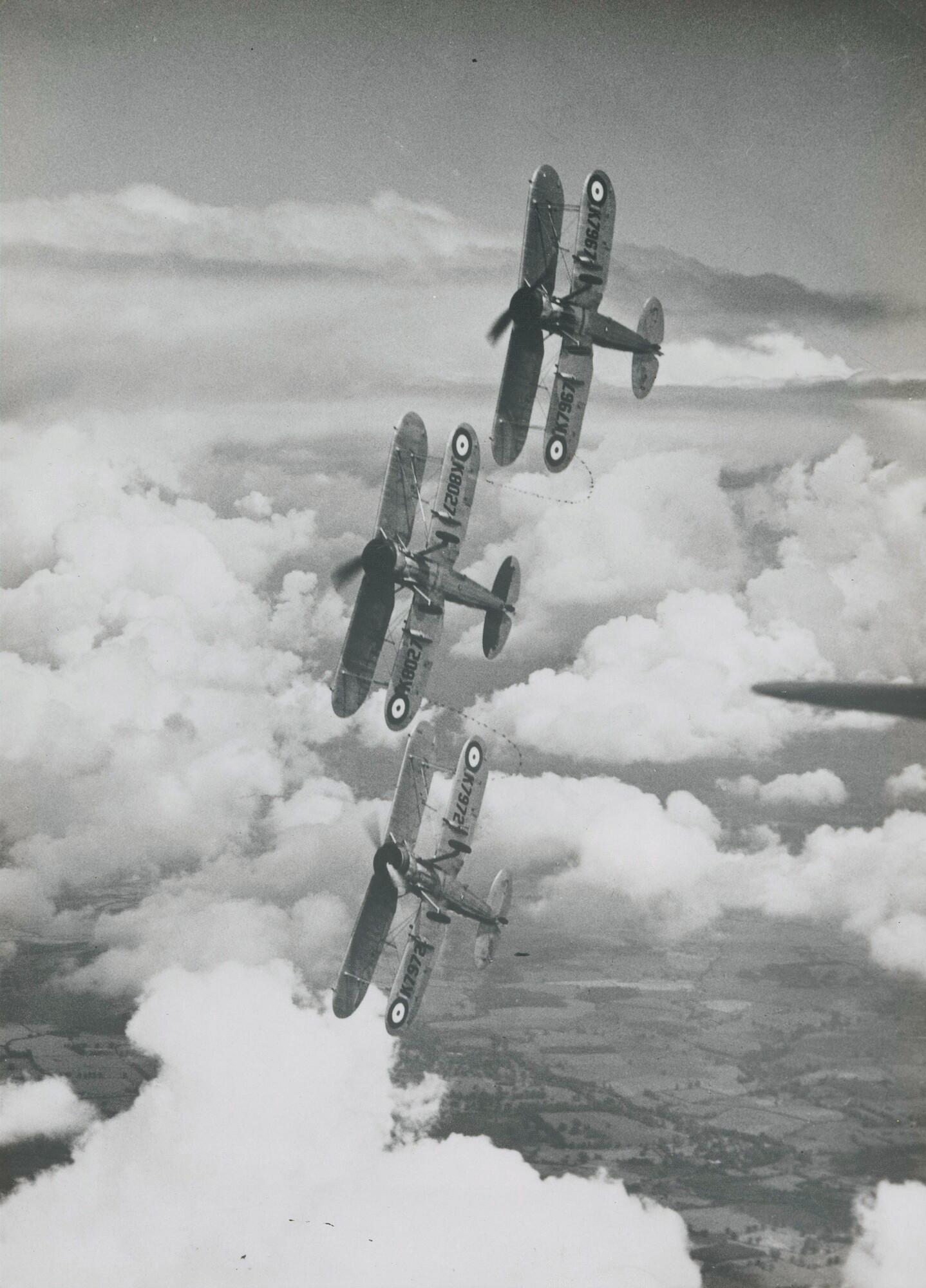 Three Gladiators of No.87 Sqdn. RAF, based at Debden, flew an aerobatic sequence while tied together by cords linking their wing struts at the 1938 Villa Coublay display, France.